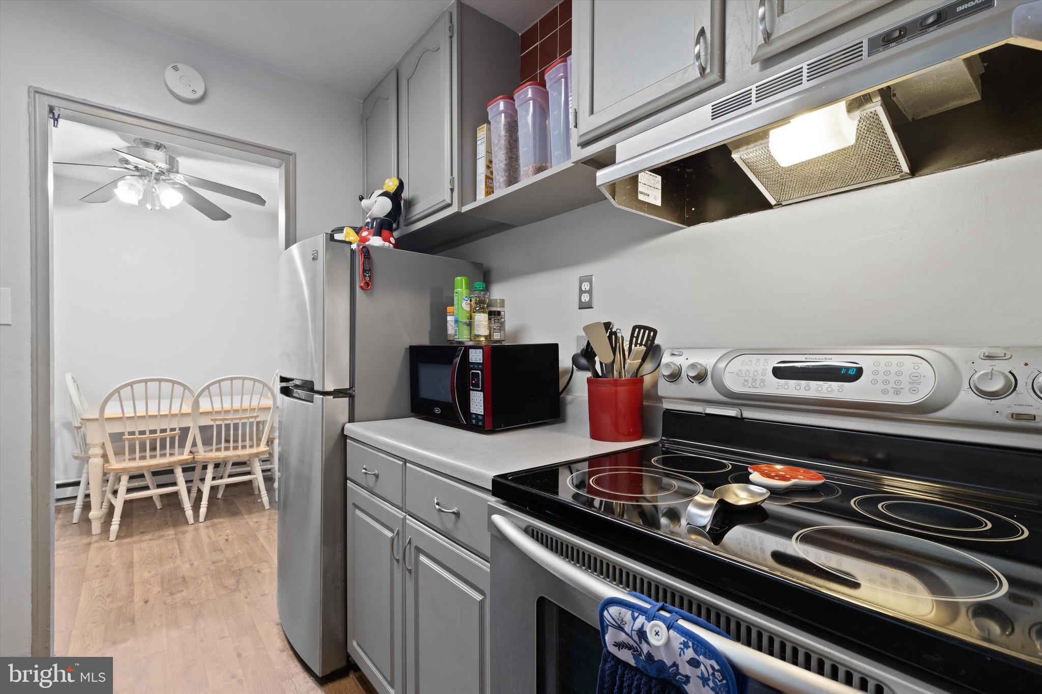 a kitchen with a stove and a dining table