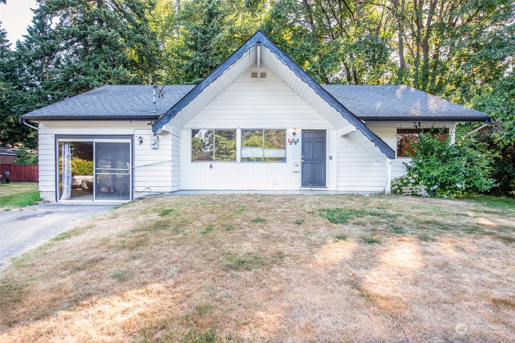 a view of a house with a yard and garage