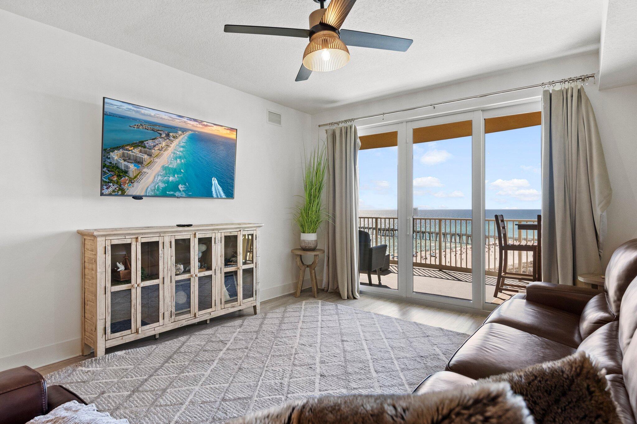 a living room with furniture and a floor to ceiling window