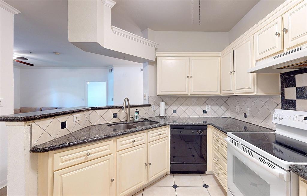 a kitchen with granite countertop white cabinets and white appliances