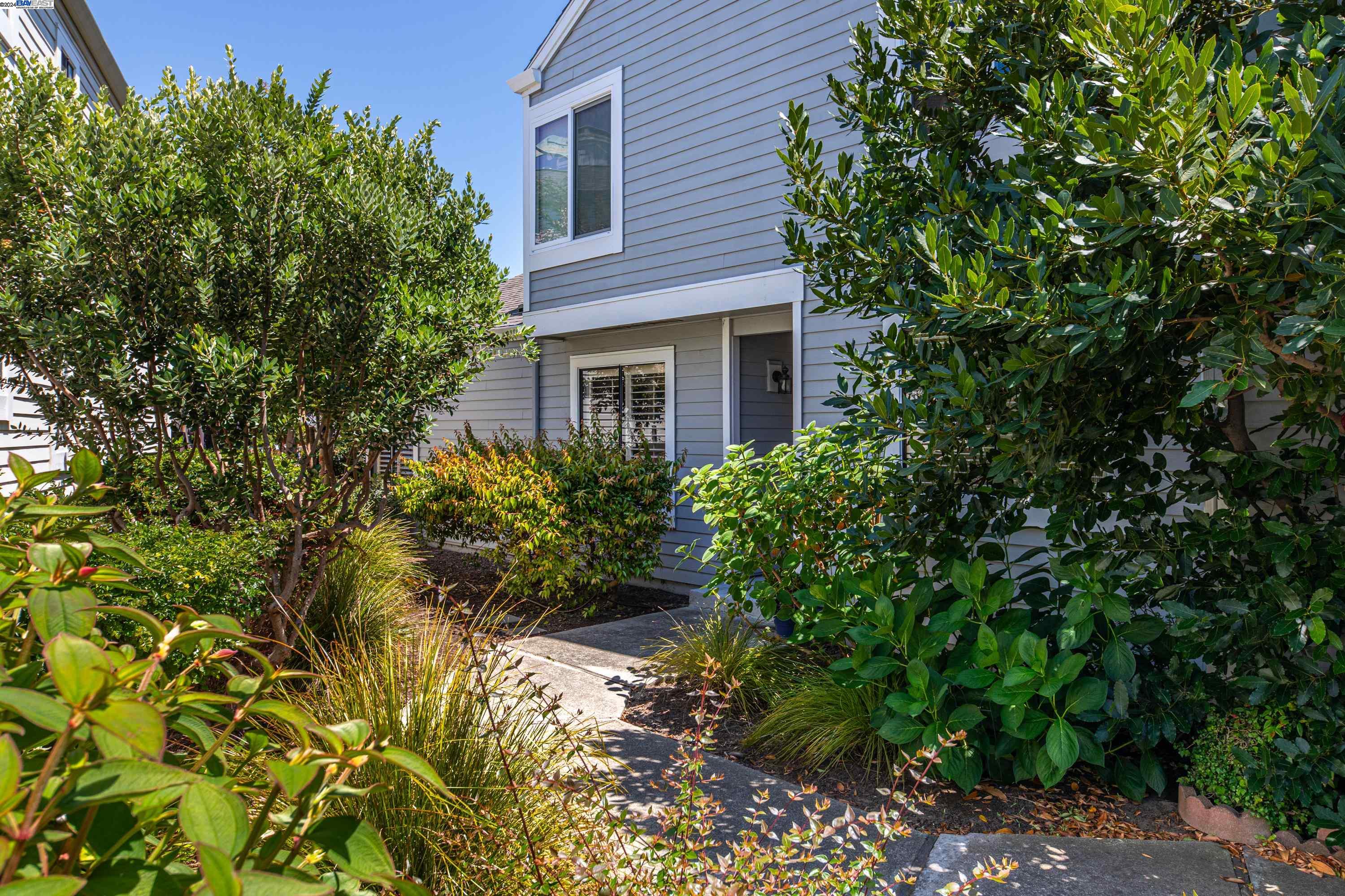 a front view of a house with a garden