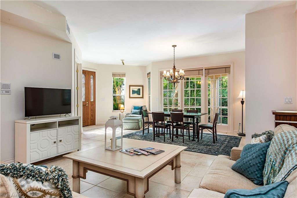 Tiled living room featuring a chandelier