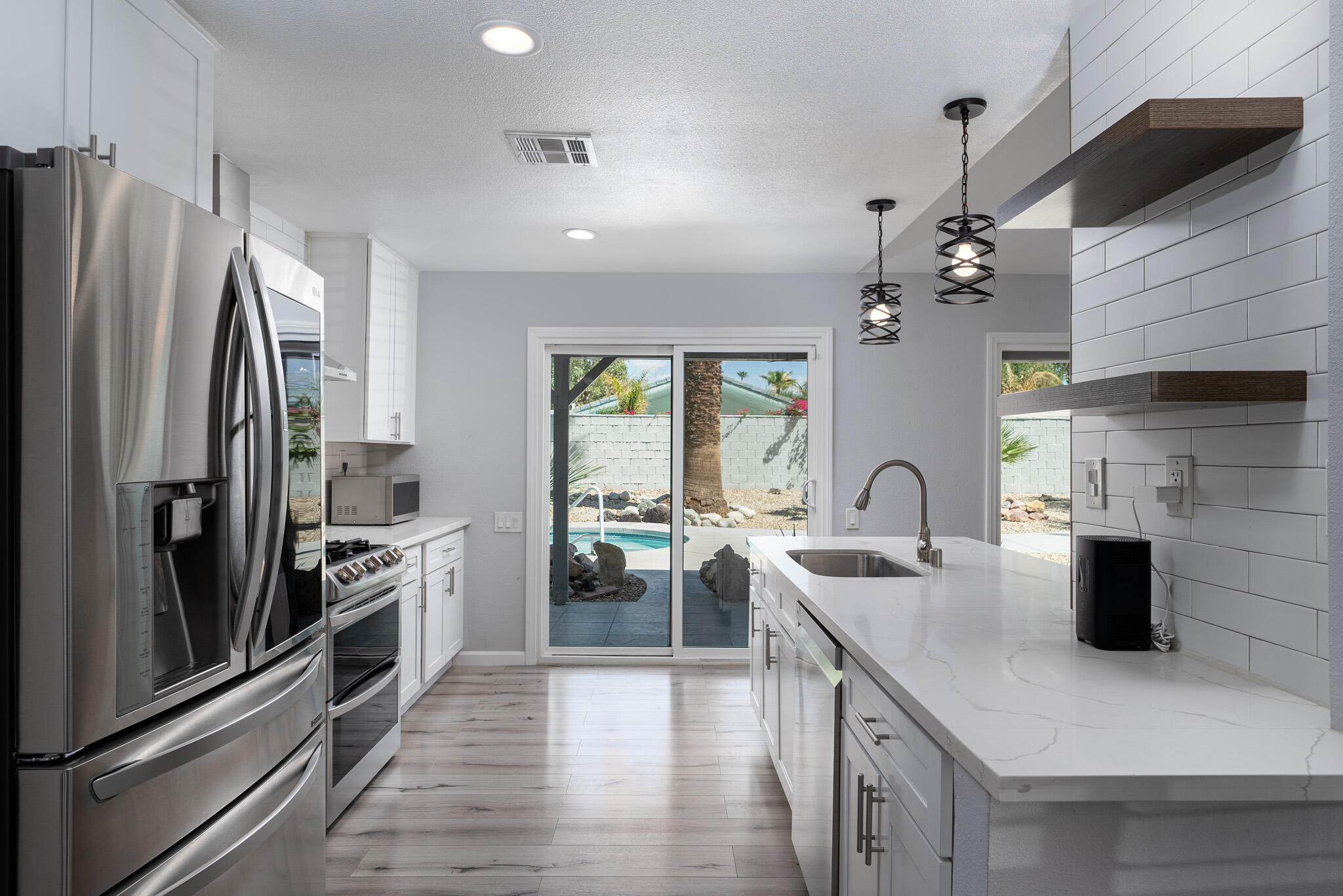 a kitchen with a refrigerator and a sink