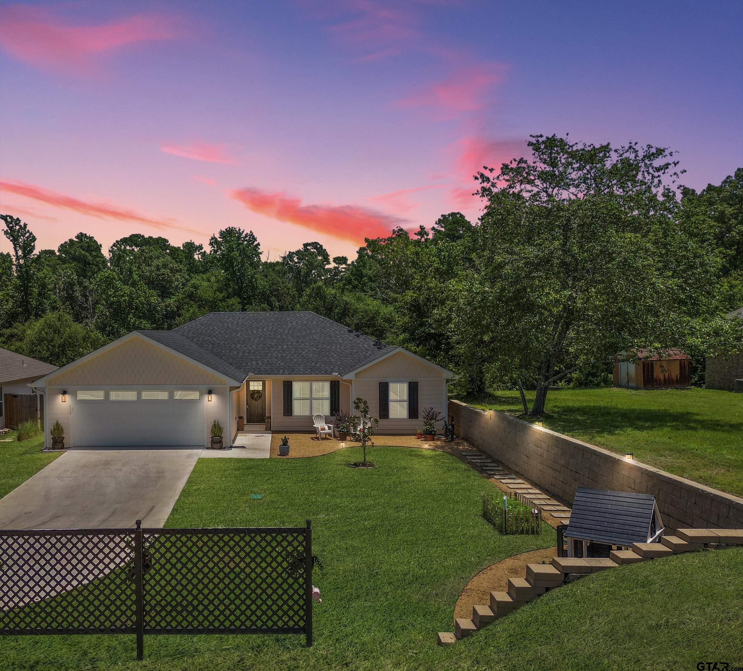 a front view of a house with garden