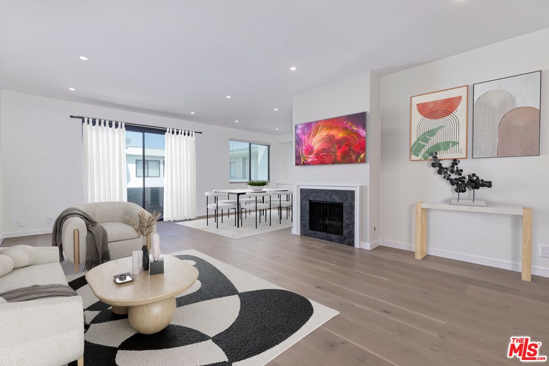 a living room with fireplace furniture and a fireplace