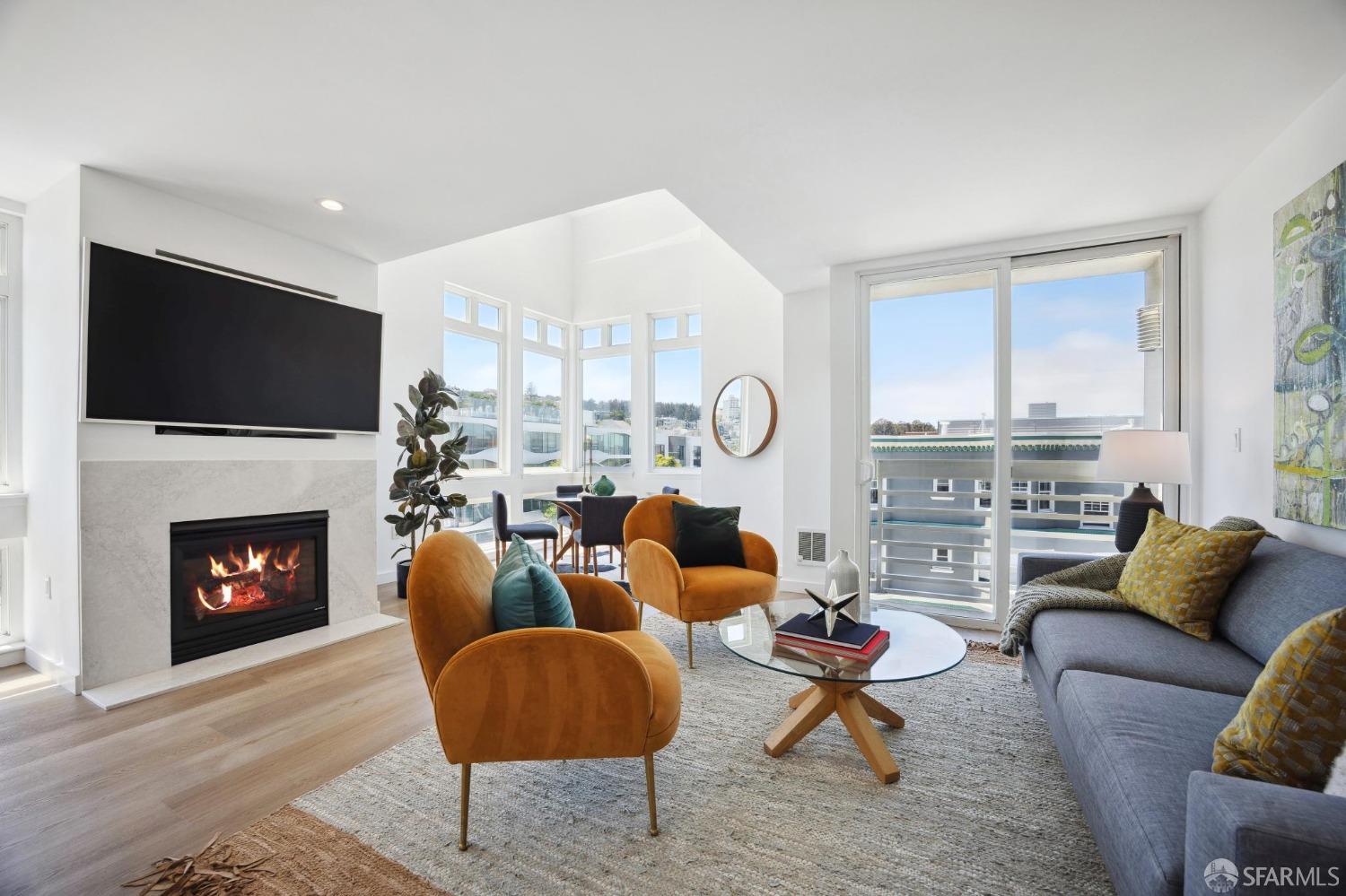 a living room with furniture a fireplace and a flat screen tv