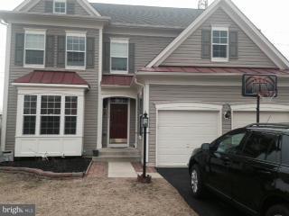 a front view of a house with parking space