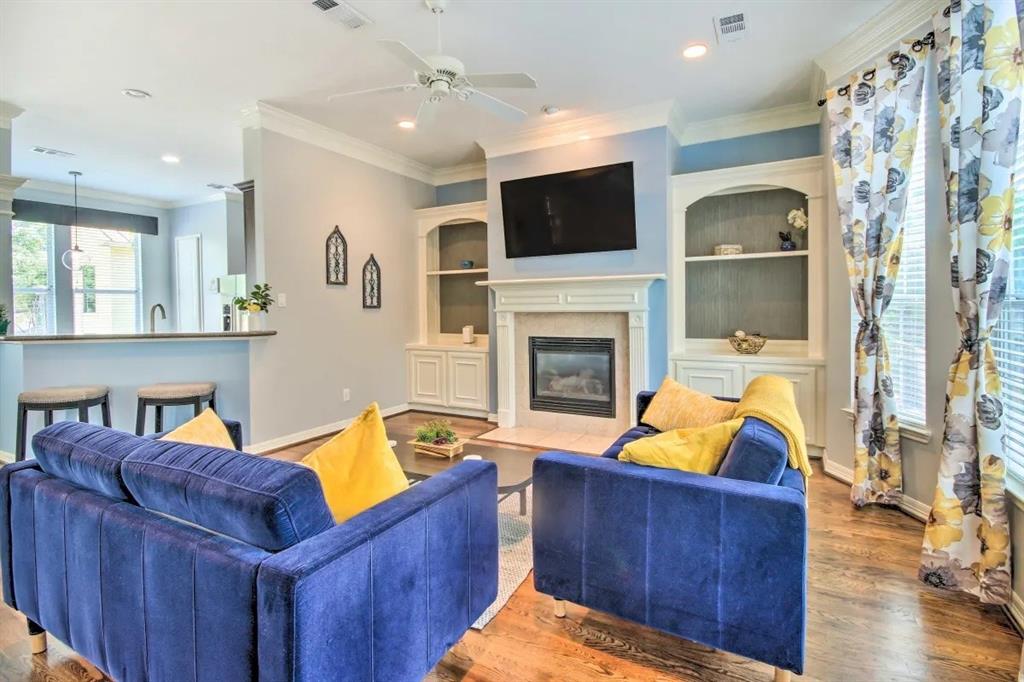 a living room with furniture fireplace and flat screen tv