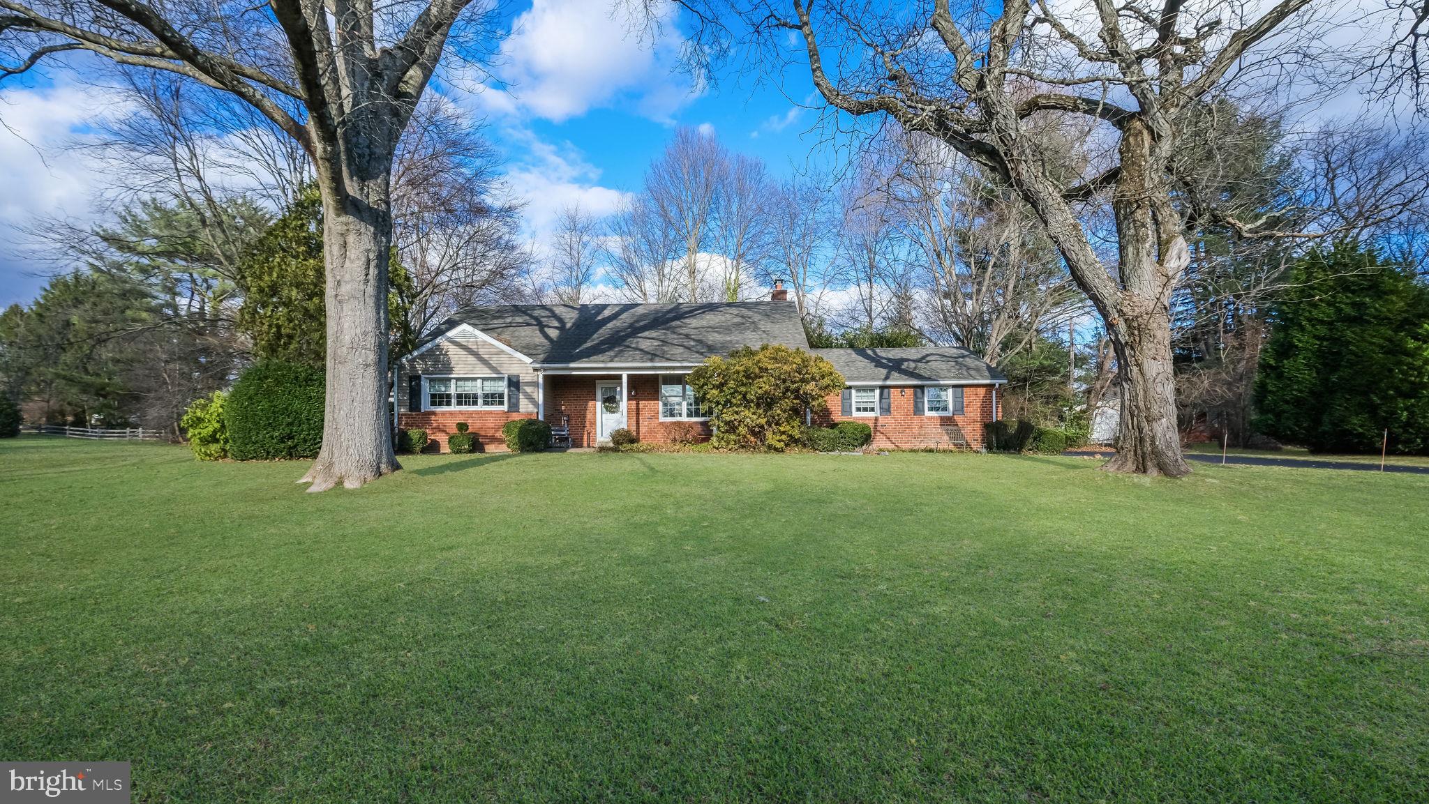 a view of a yard with a house in the background