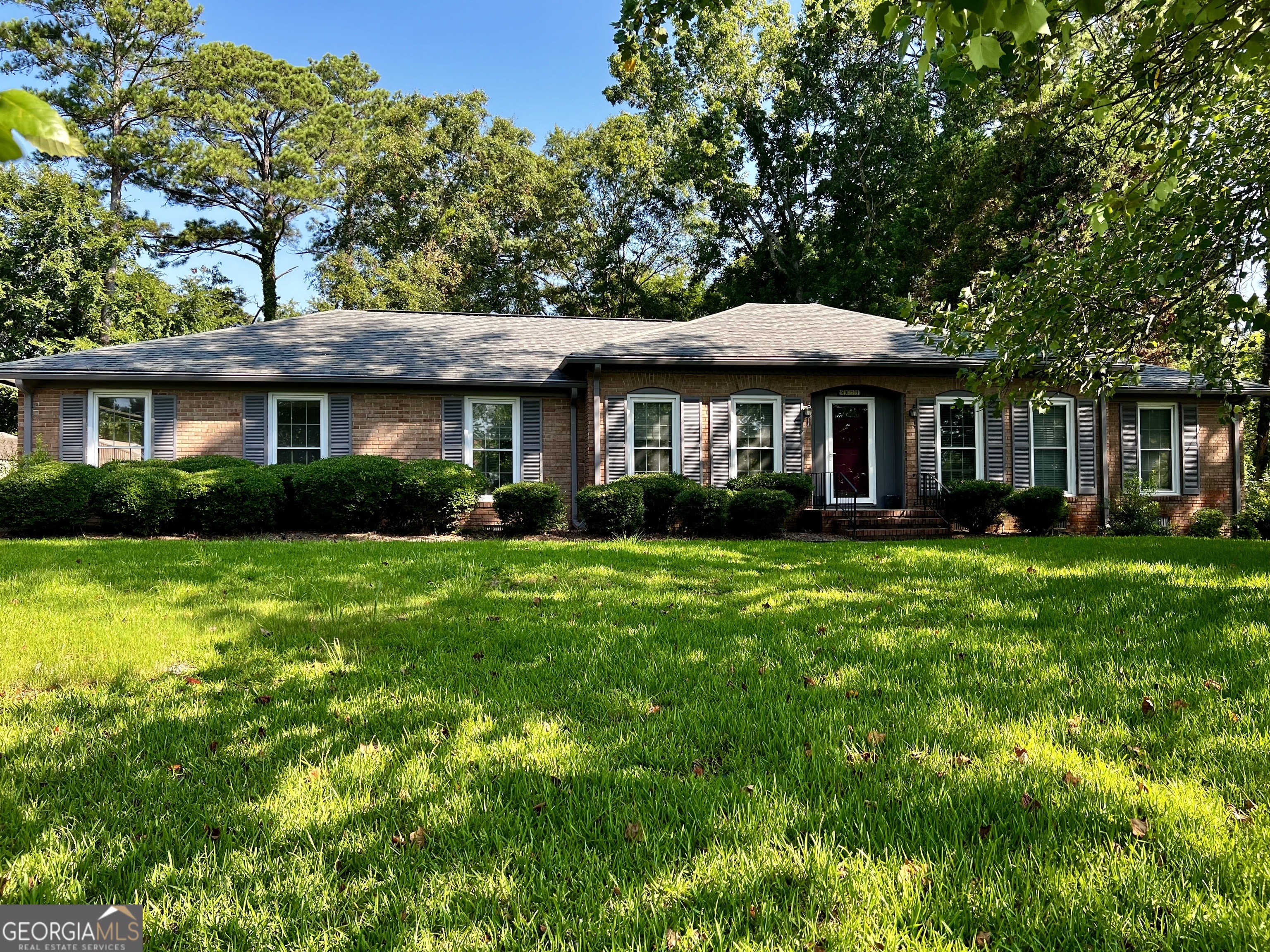 a front view of a house with a garden