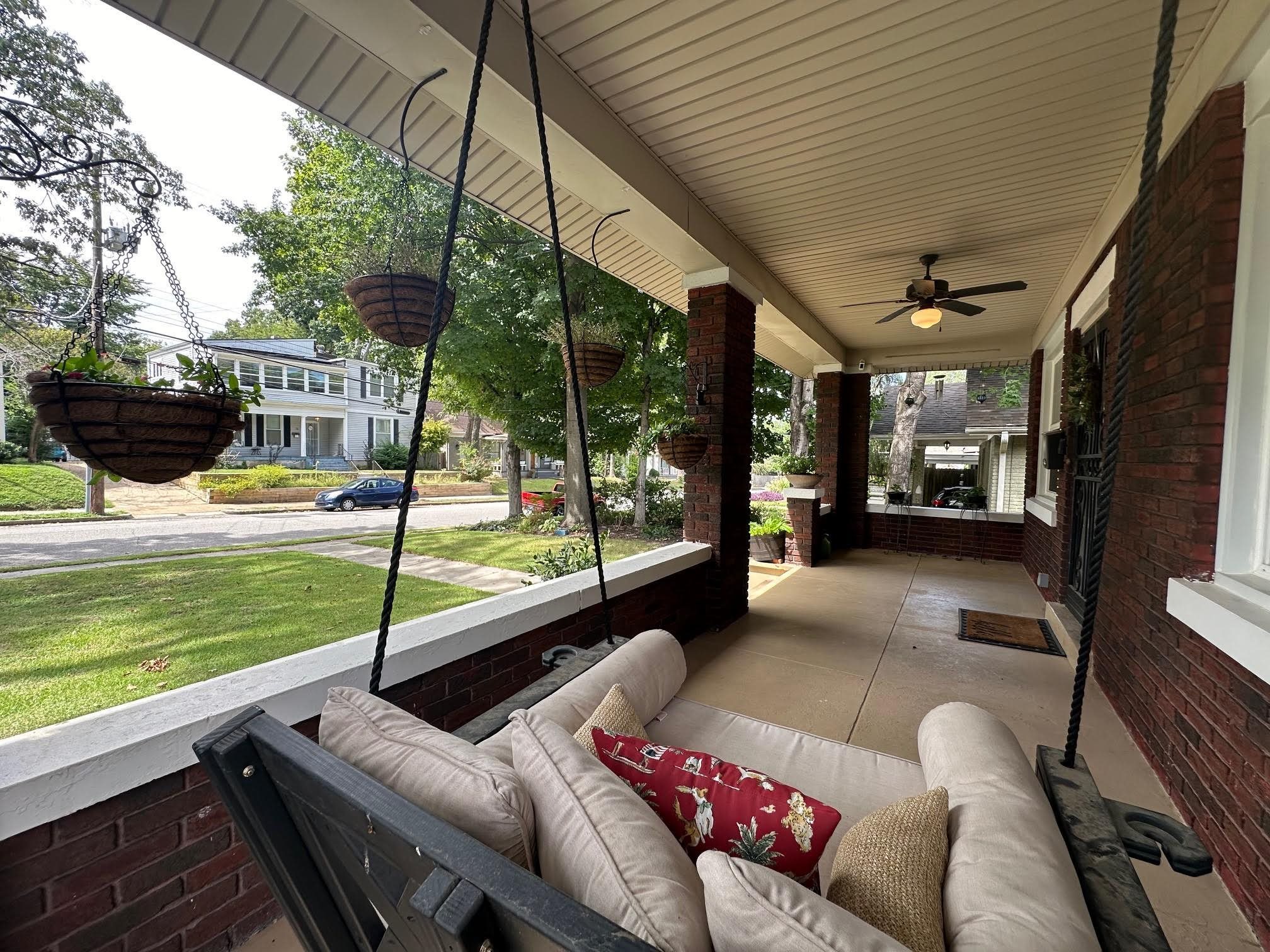 a view of a porch with furniture and a yard