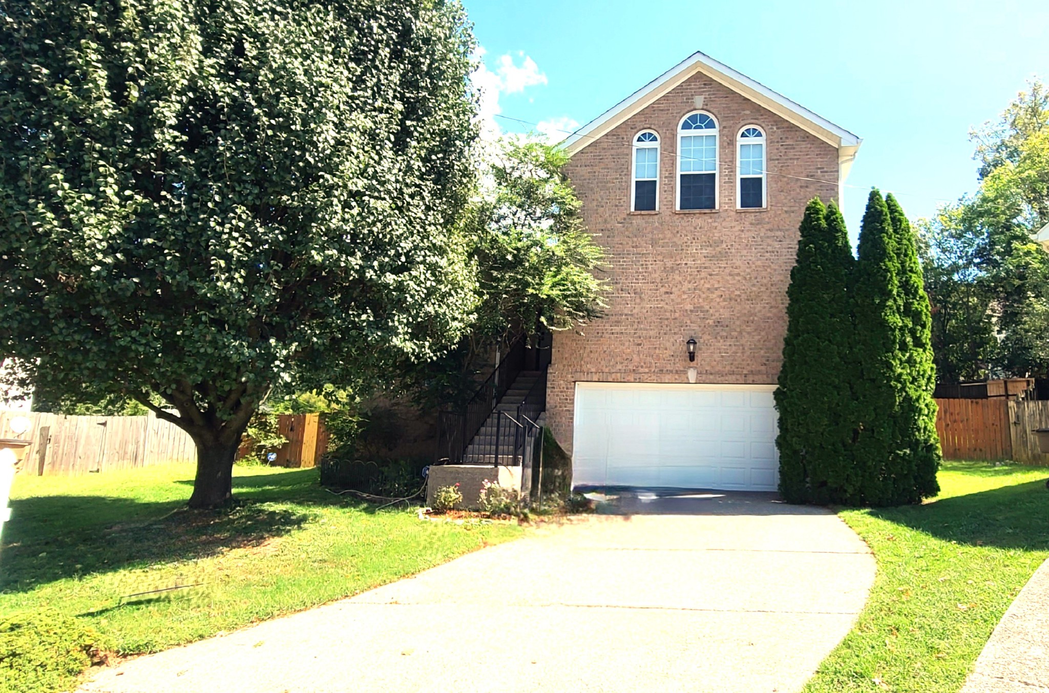 a front view of house with yard and trees