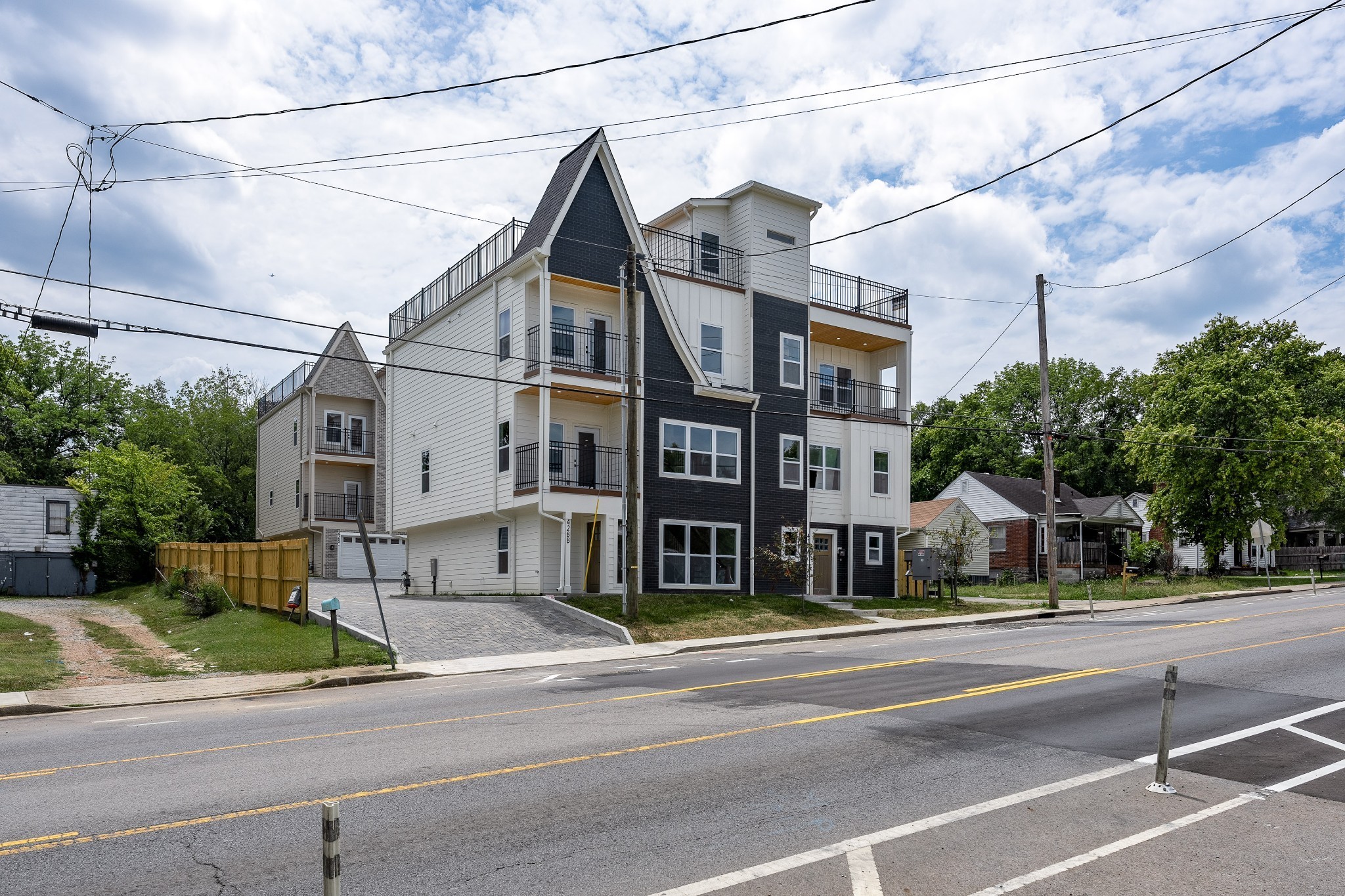 Exterior Photo. Shows shared driveway that leads to each unit's 2 Car Garages. Also includes 4 additional parking pads one surface space per Unit ideal for Guests.