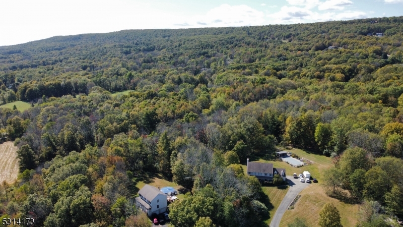 an aerial view of house with yard and mountain view