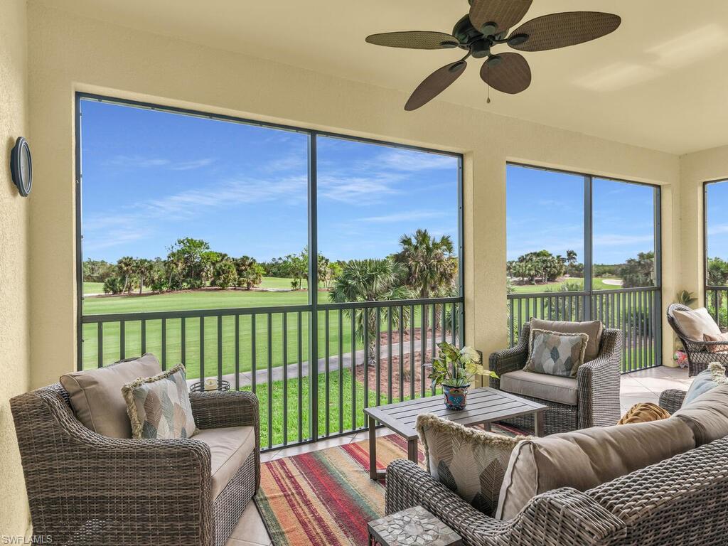 a living room with furniture and a floor to ceiling window