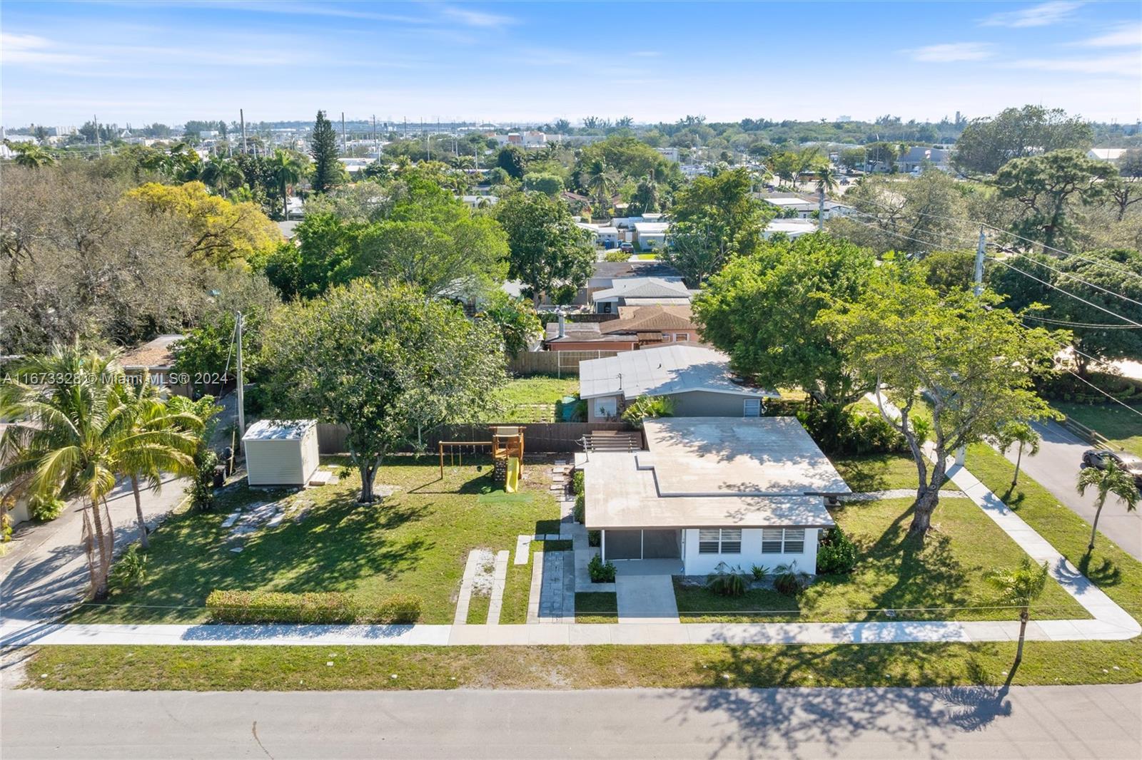 an aerial view of a house with a yard basket ball court and outdoor seating