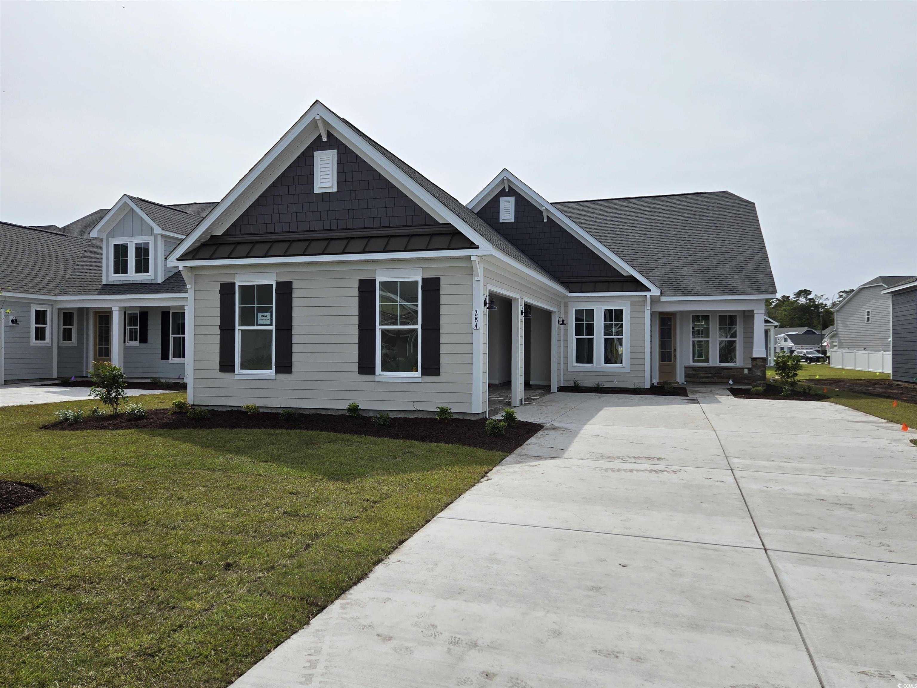 Craftsman-style home with a front lawn