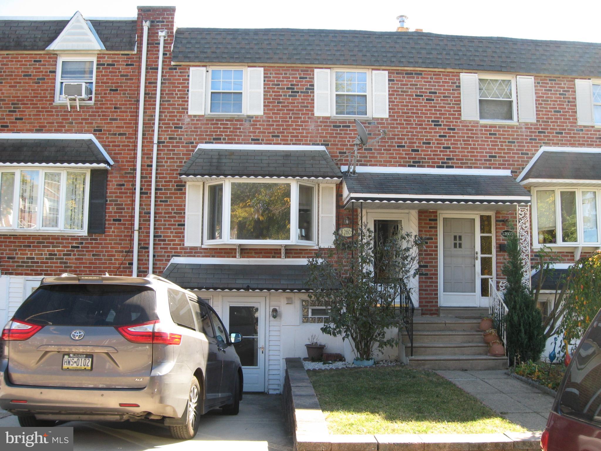 a front view of a house with yard