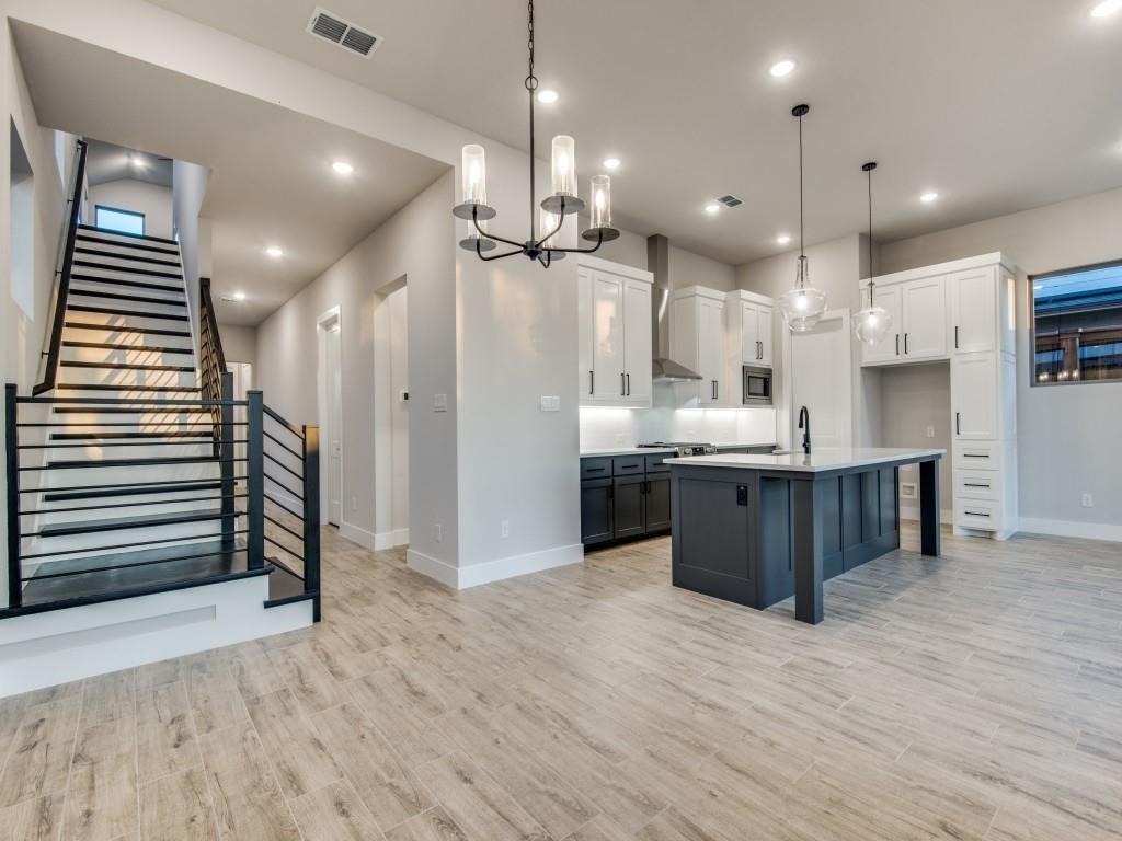 a large kitchen with kitchen island a sink stainless steel appliances and cabinets