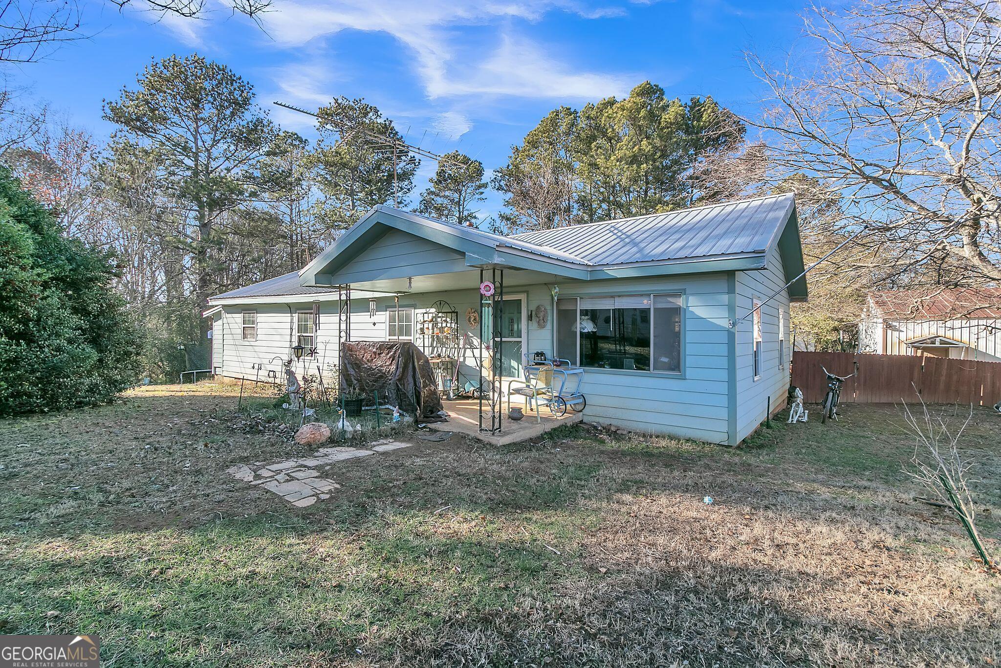 a view of a house with a yard and porch