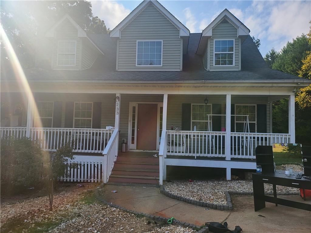 a view of a house with a bench in front of gate