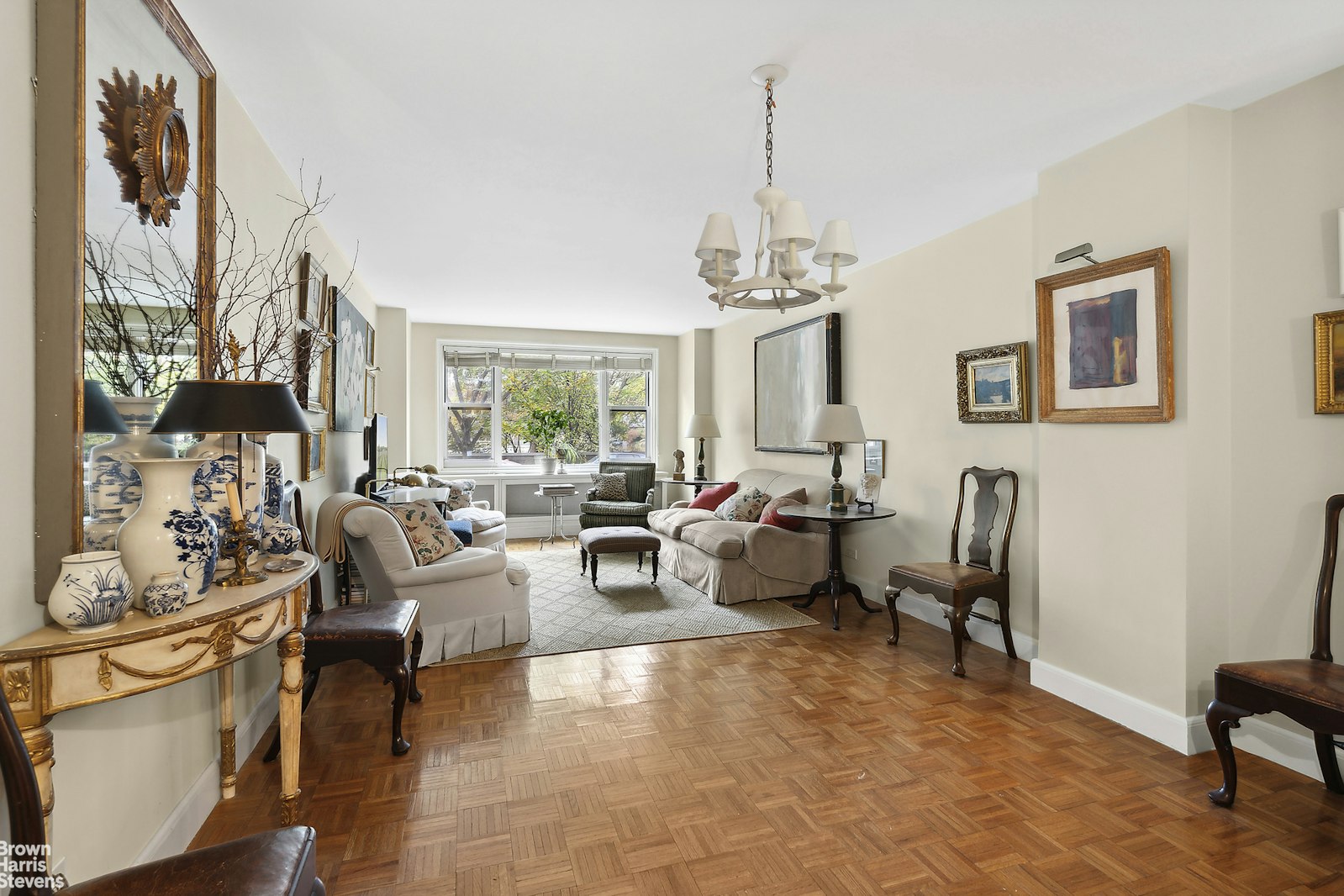 a living room with furniture and a chandelier