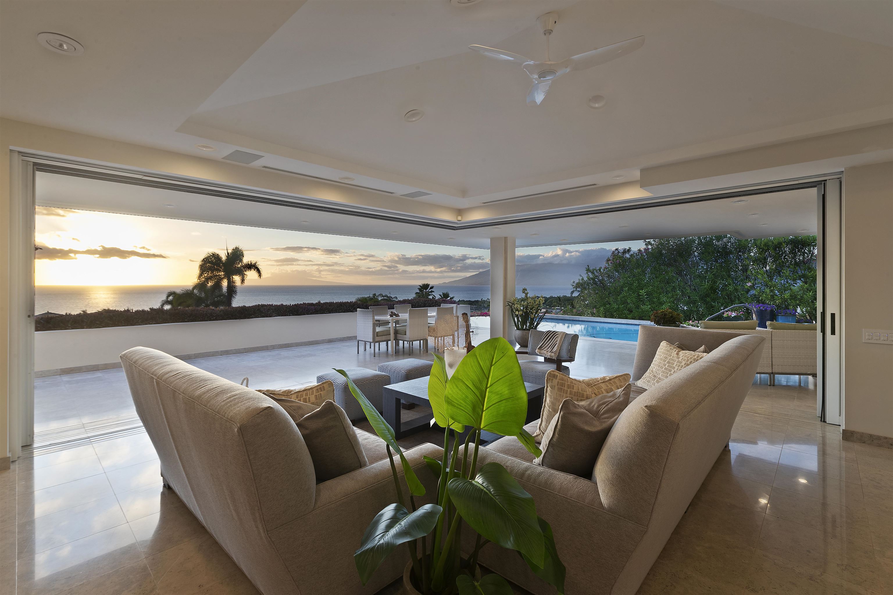 a view of a living room and dining room with furniture window and outside view