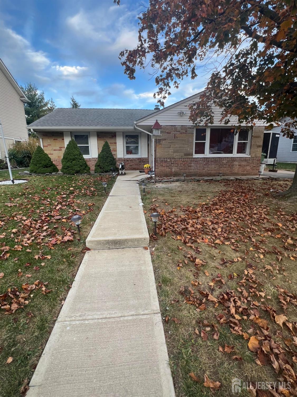 a front view of a house with a garden