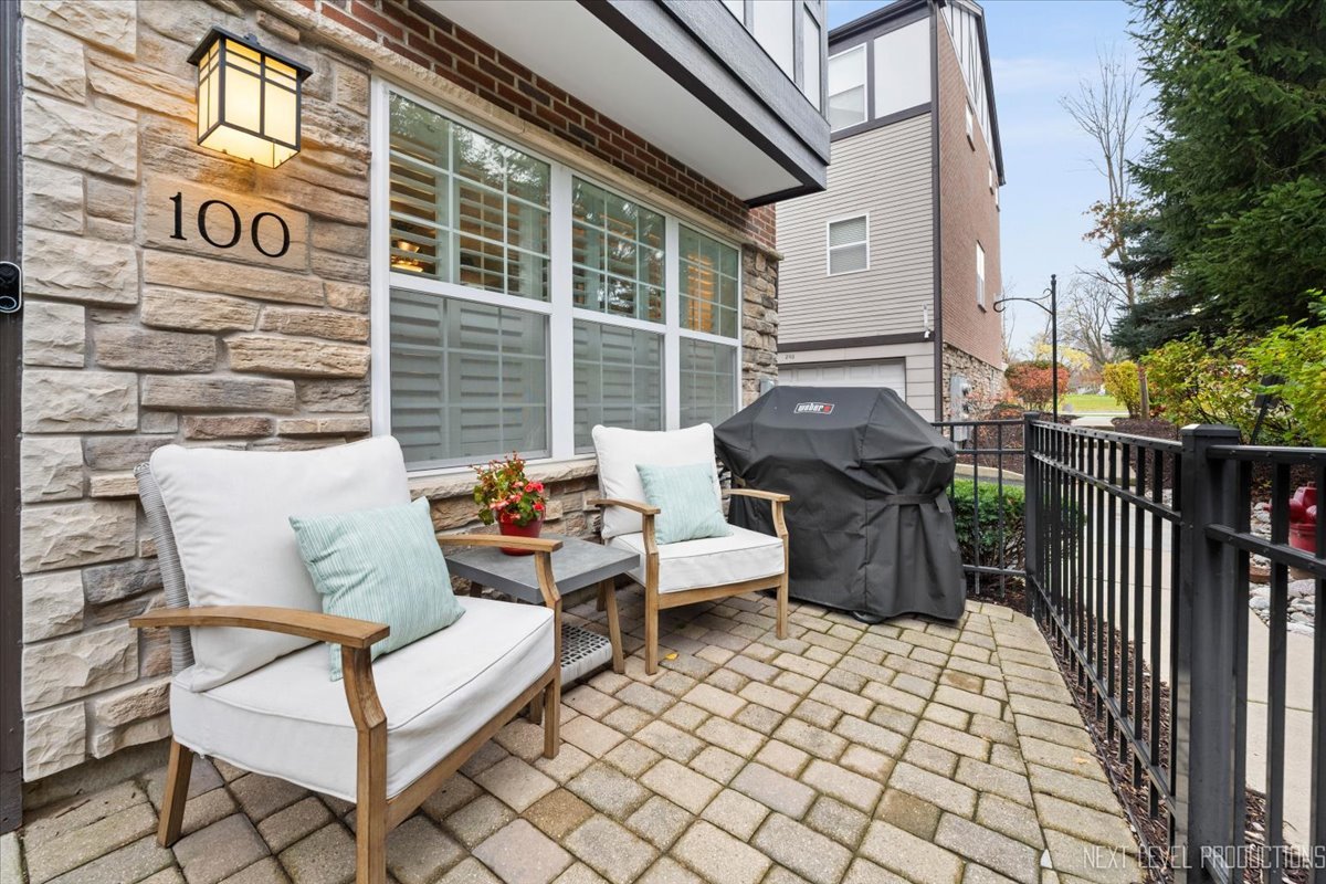 a view of a patio with a table and chairs