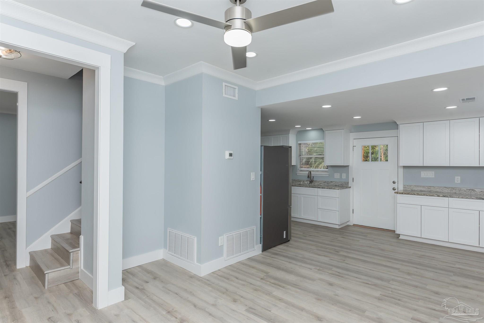 a view of a kitchen with wooden floor and a kitchen