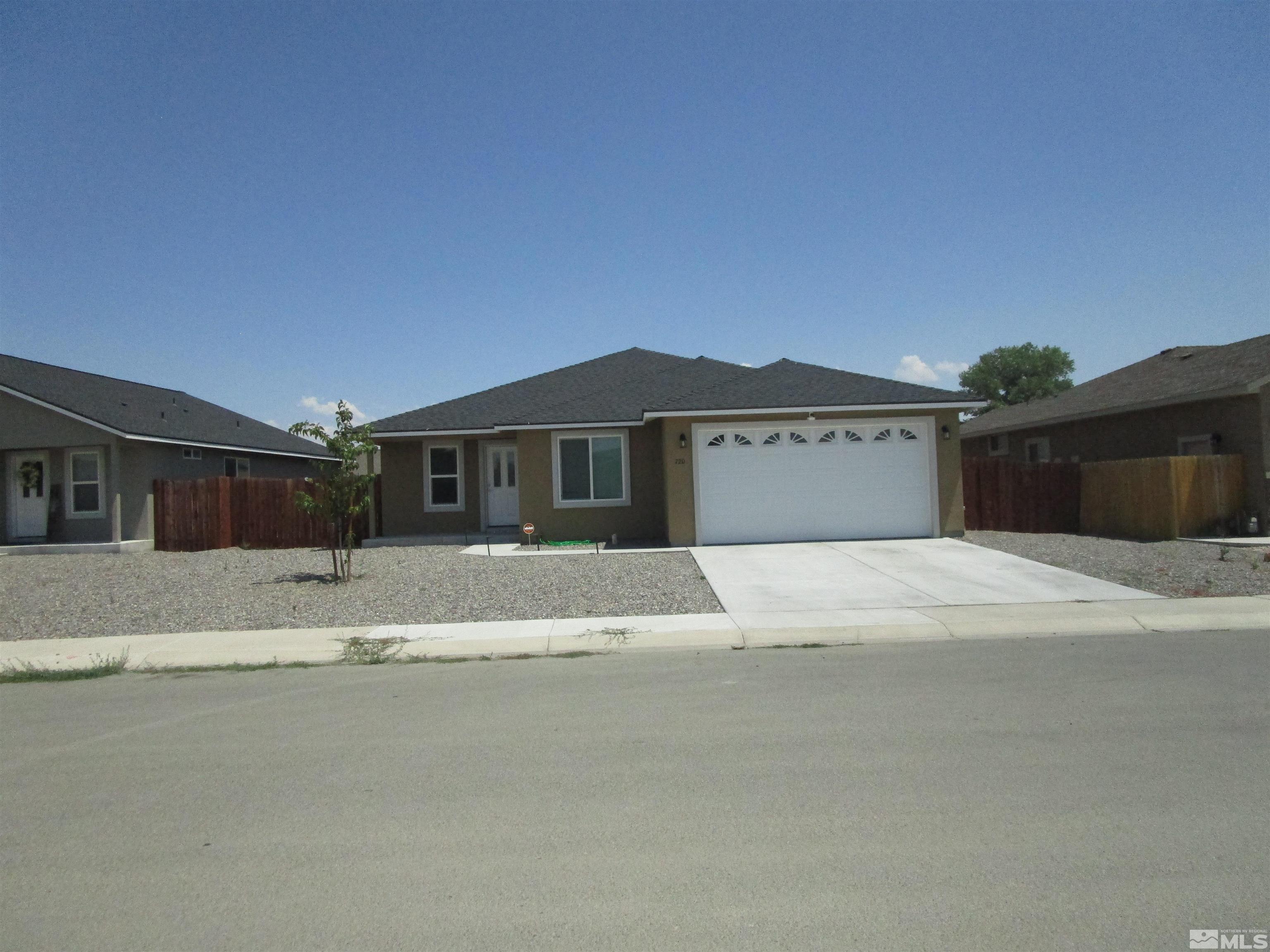 a front view of a house with a yard and a garage