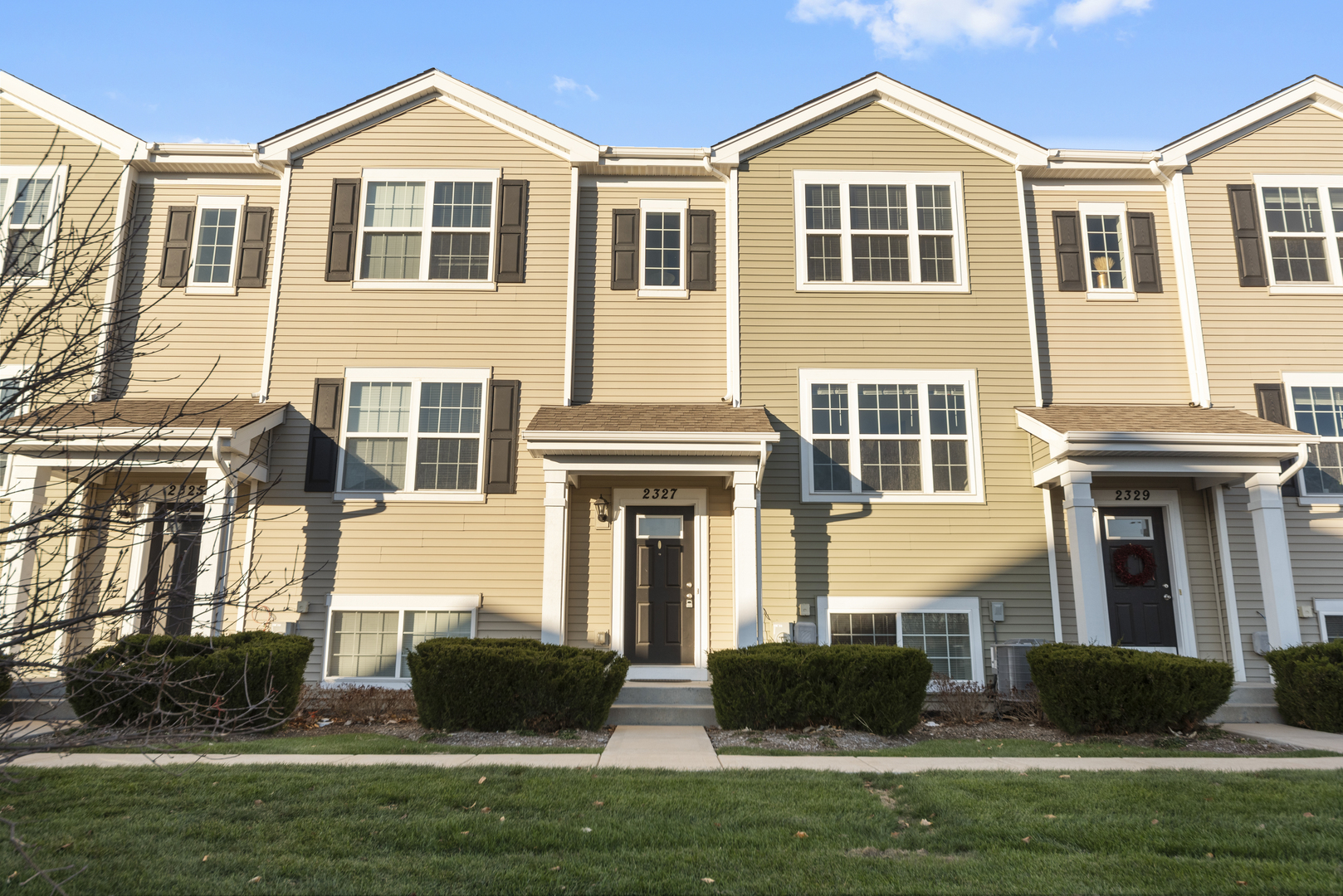 a front view of a house with a yard