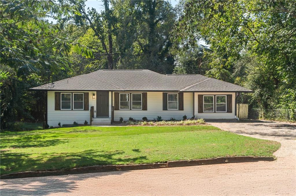 a front view of a house with a garden