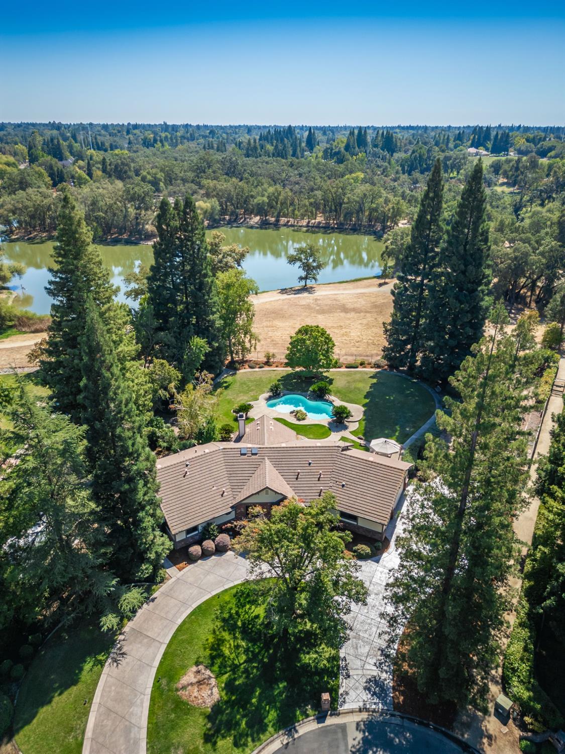 an aerial view of house with yard swimming pool and outdoor seating