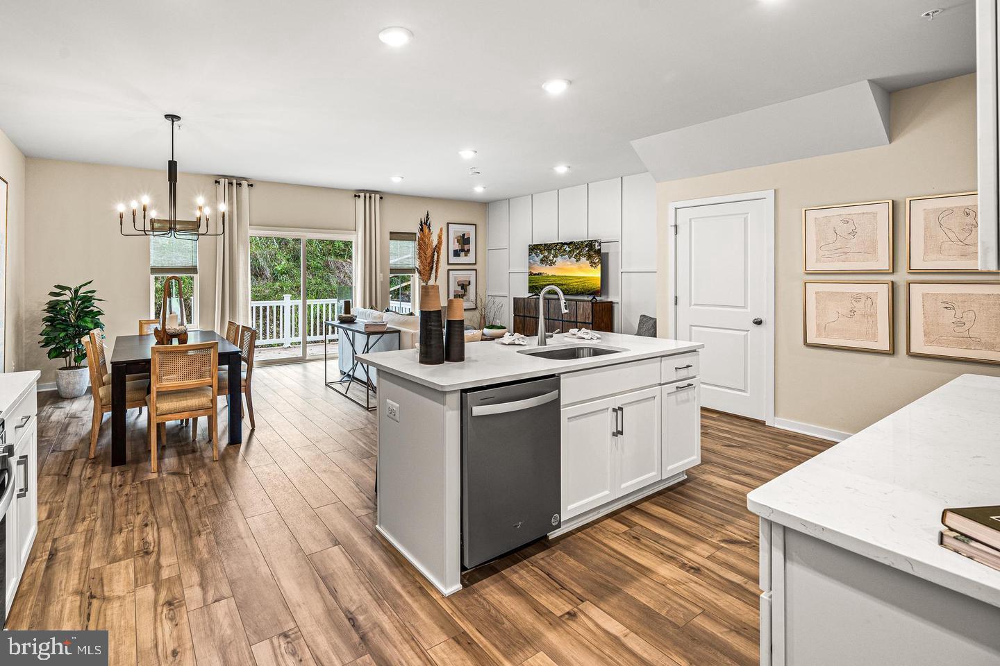 a kitchen with a sink wooden floor and white appliances