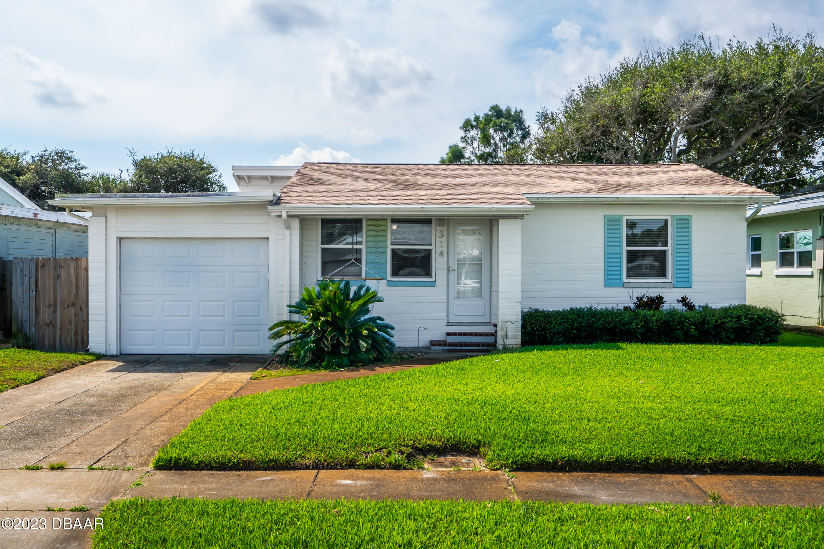 a front view of house with yard and green space