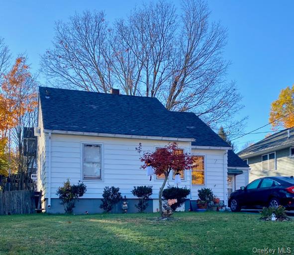 Rear view of house with a lawn