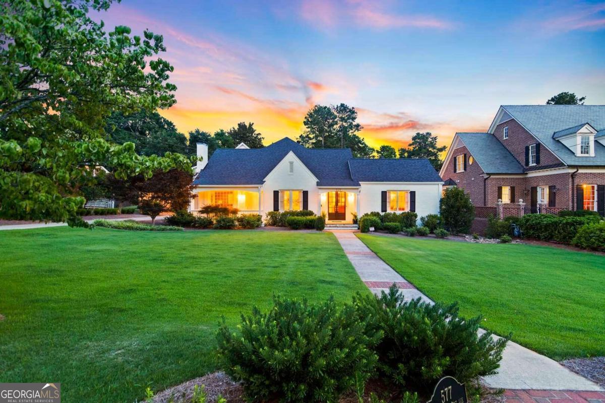 a view of house that has a yard