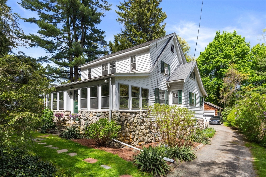 a front view of a house with a garden