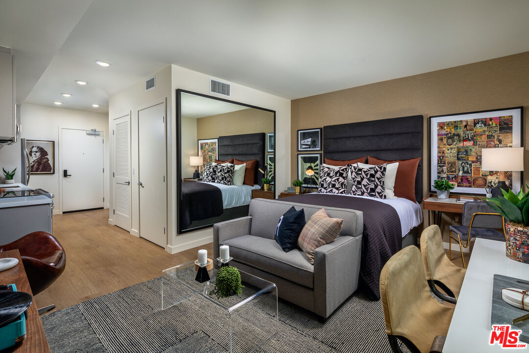 a bedroom with furniture and a flat screen tv