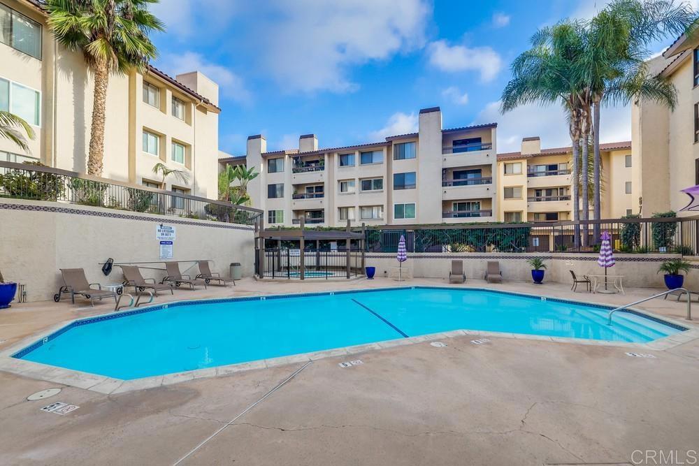 a swimming pool with outdoor seating and yard