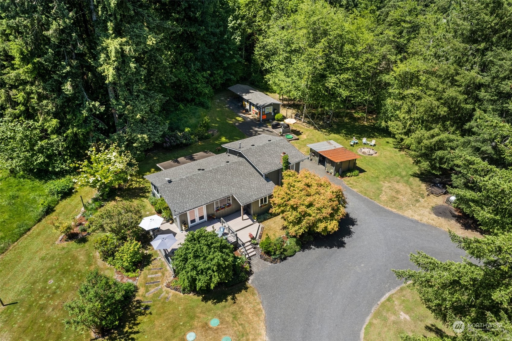 an aerial view of a house with a yard and trees