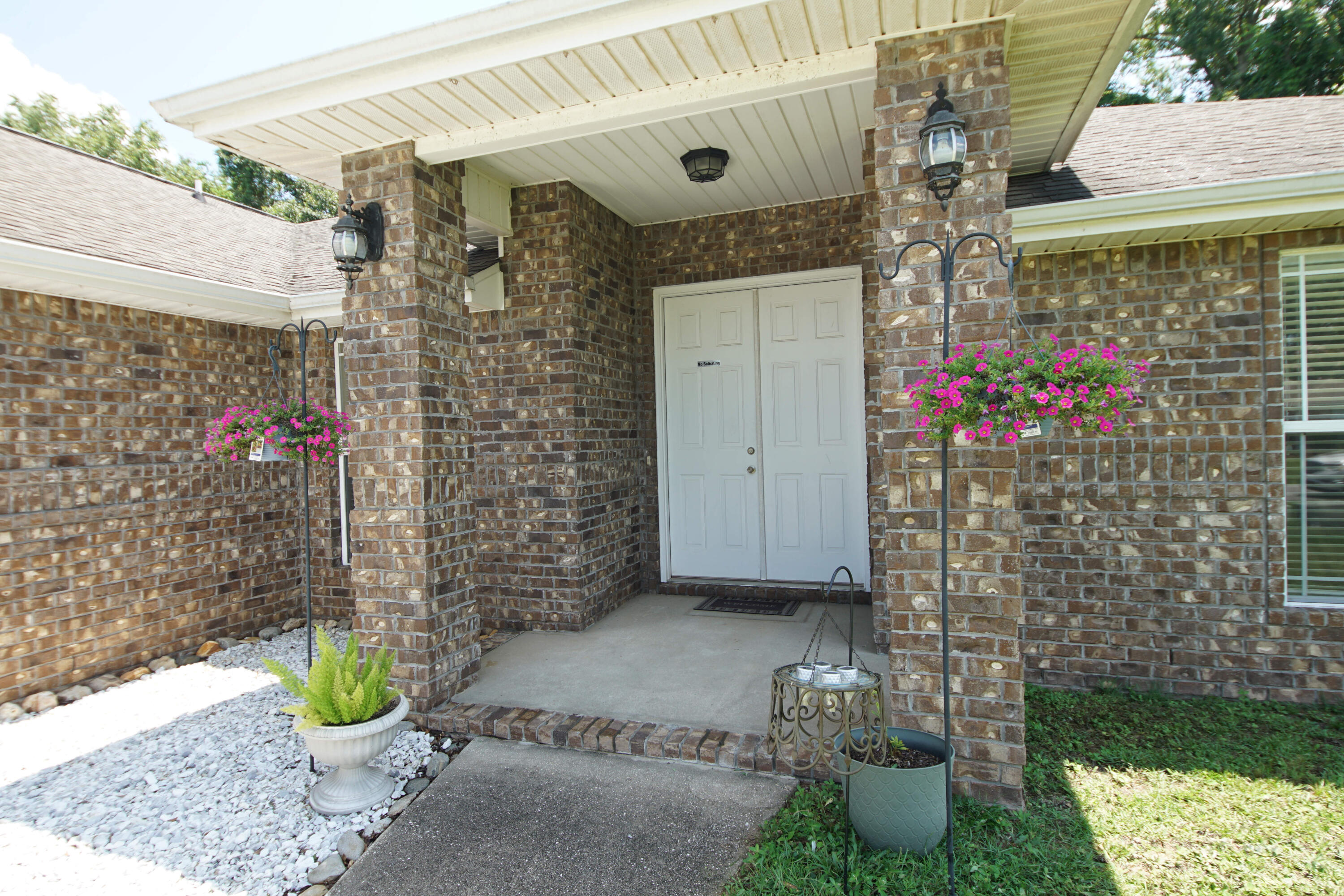 a front view of a house with outdoor space and seating area