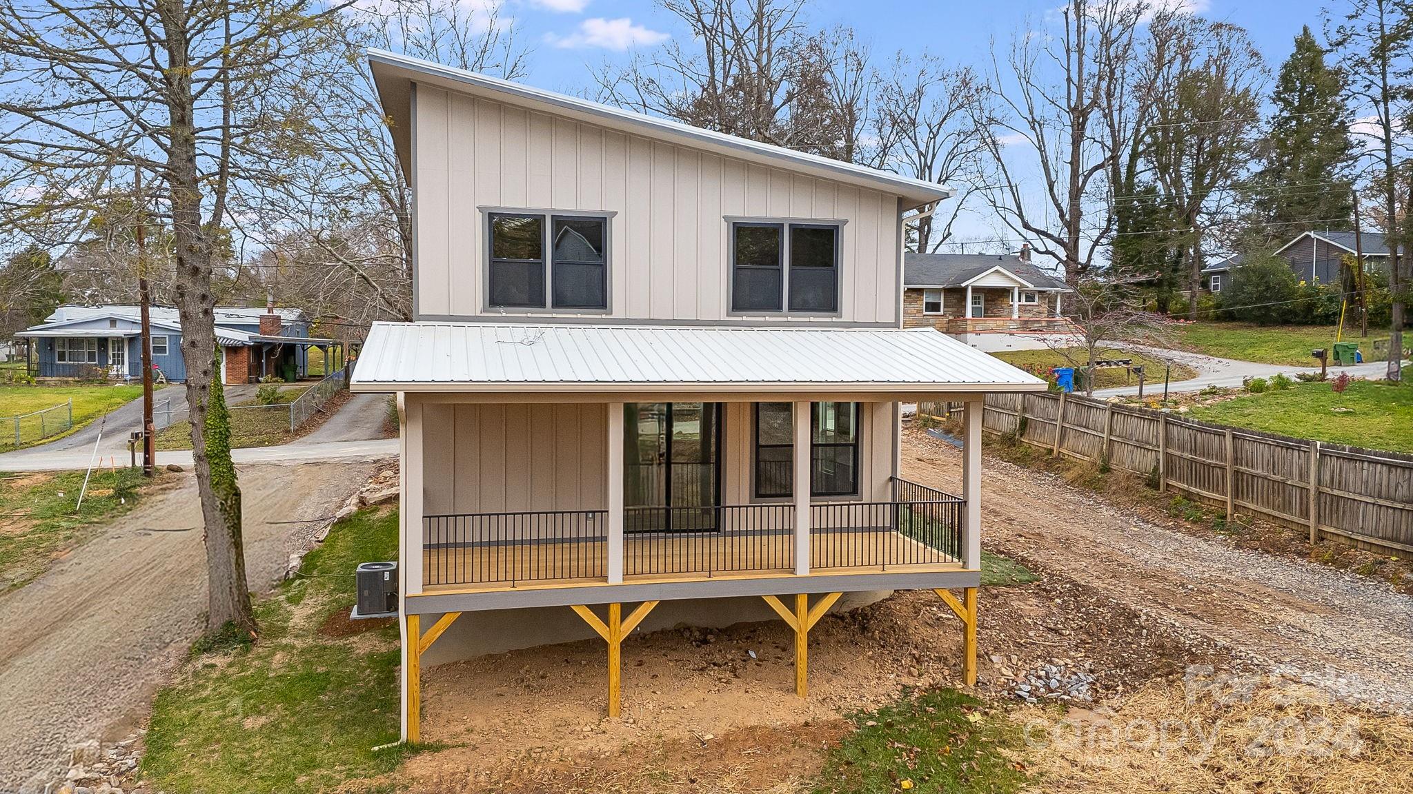 a view of a house with backyard and a tree