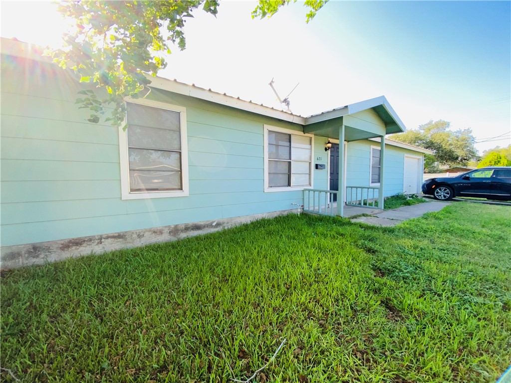 a front view of house with yard and green space