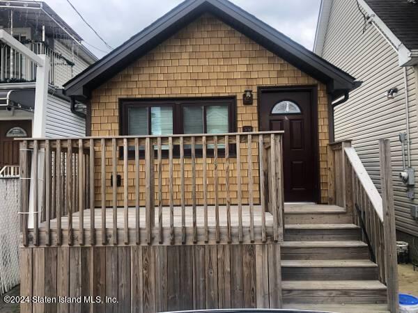 a front view of a house with wooden fence