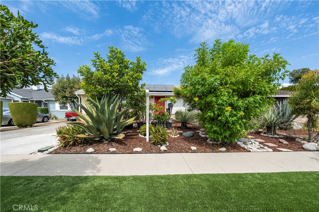 a view of backyard with outdoor seating and green space