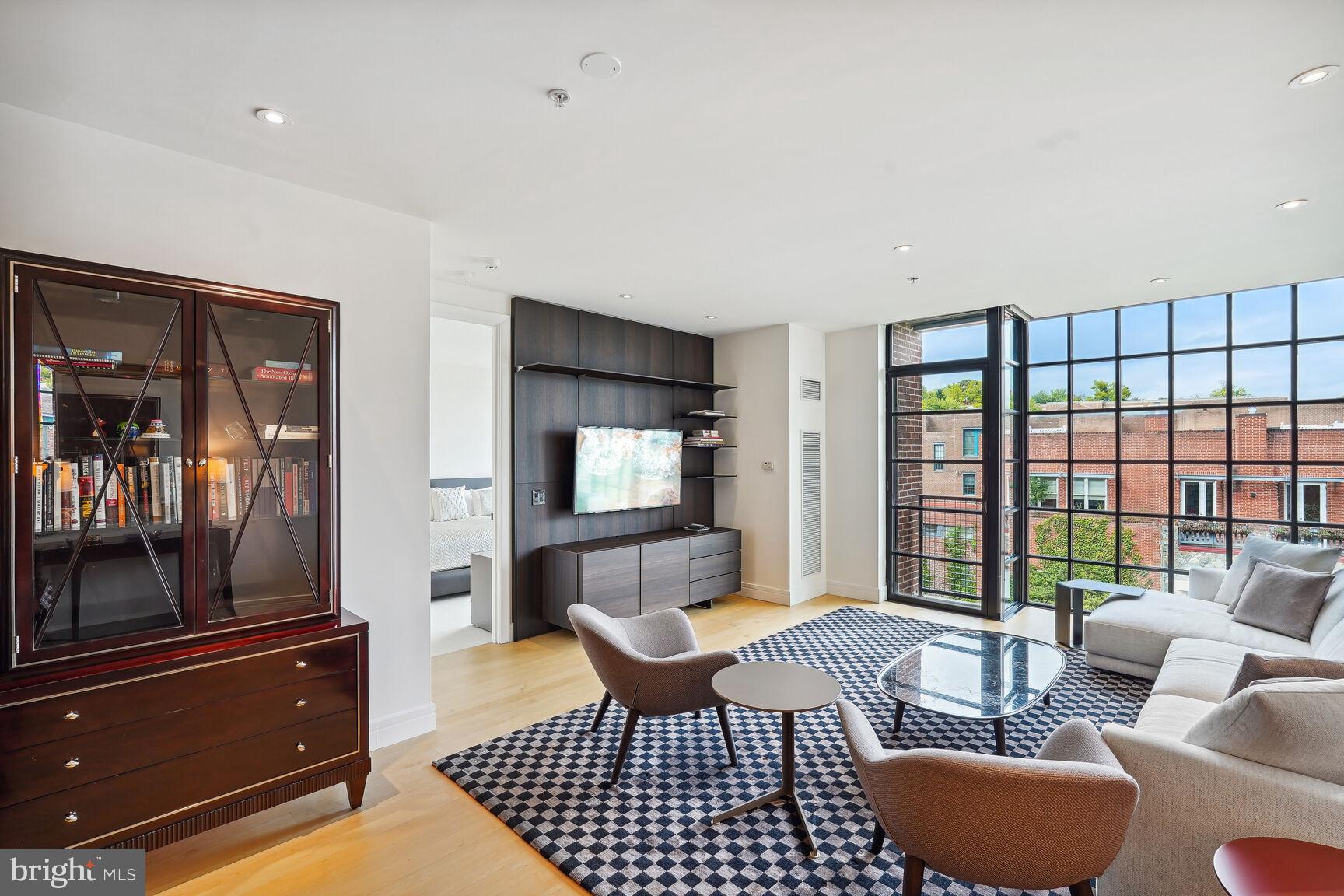 a living room with furniture and a floor to ceiling window