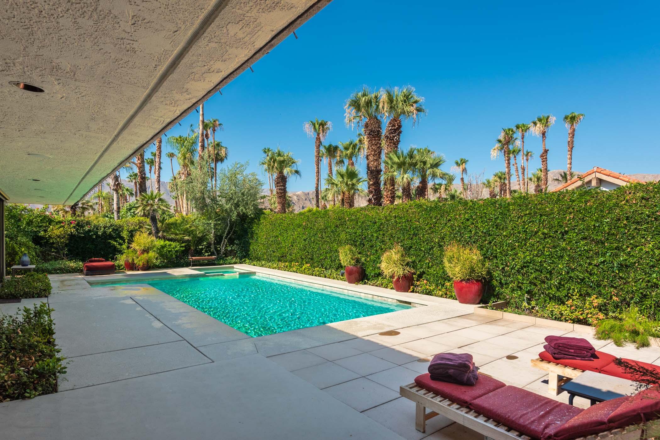 a view of a patio with table and chairs potted plants