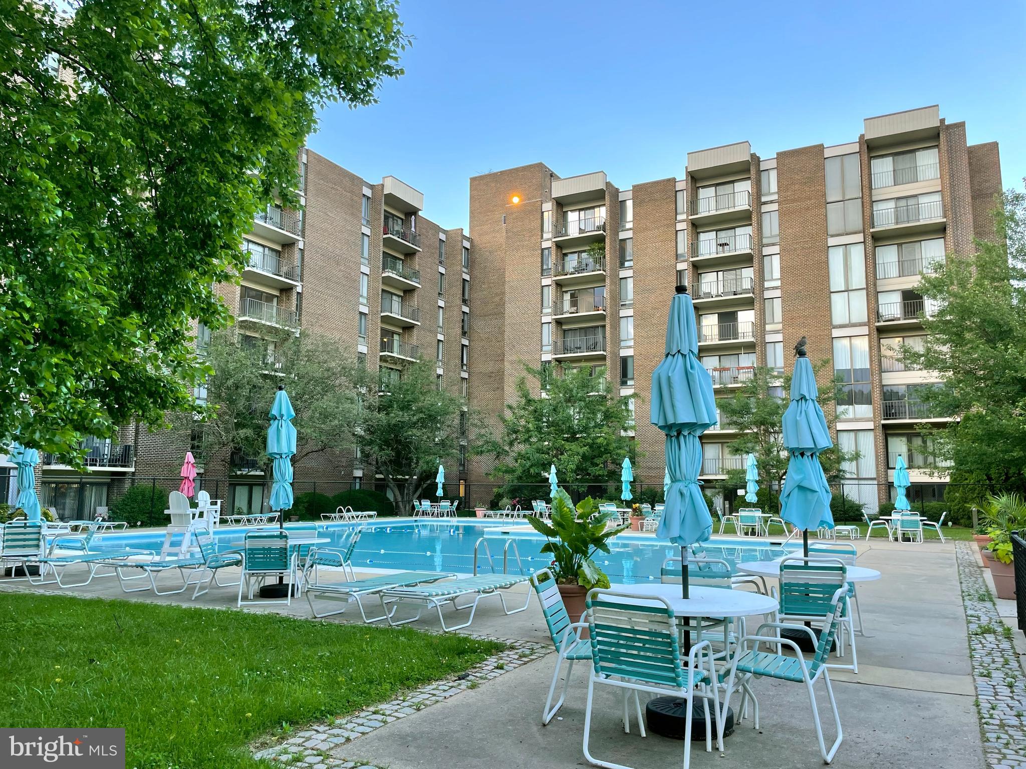 a view of a building with a yard and sitting area